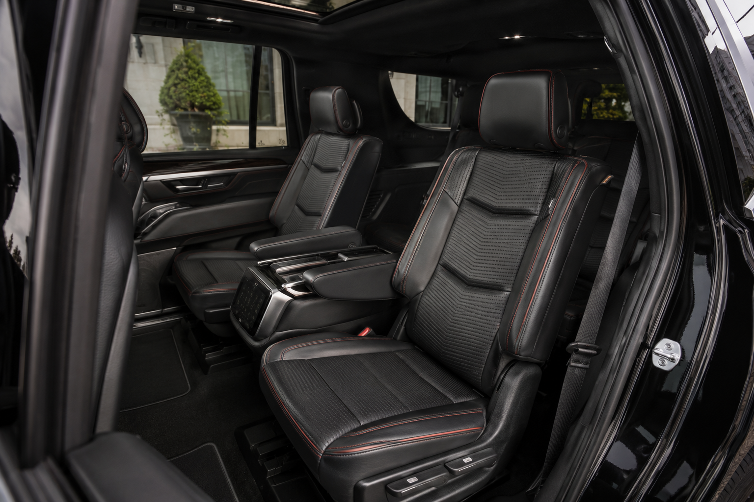 Escalade rear cabin &middot; captain chairs, red-stitched perforated leather