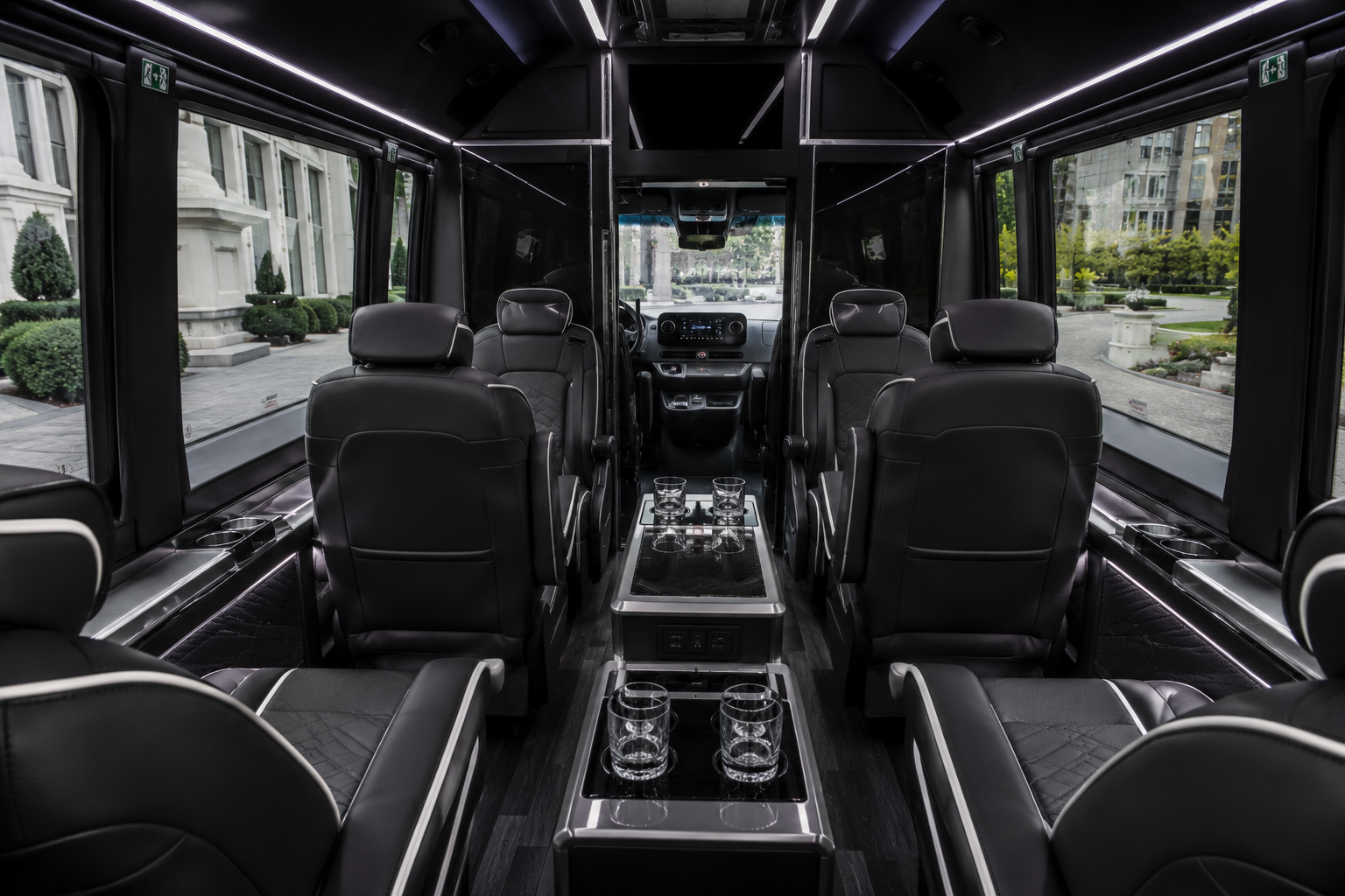 Sprinter lounge cabin &middot; facing captain chairs, centre console with USB